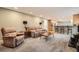 Cozy living room with plush seating, a dark wood coffee table and an open view into the kitchen at 7823 S Locust Ct, Centennial, CO 80112