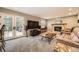 Comfortable living room with a fireplace, plush seating, and French doors leading to the outdoor deck at 7823 S Locust Ct, Centennial, CO 80112