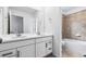 Bright bathroom featuring a double vanity with white countertops and a separate shower/tub at 3315 N Coolidge Way, Aurora, CO 80019