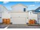 Modern two-story home with a white garage door, light sconces and contemporary wood slat features at 3315 N Coolidge Way, Aurora, CO 80019