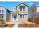 Charming two-story home with gray siding, brick accents, and a welcoming teal front door at 3315 N Coolidge Way, Aurora, CO 80019