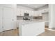 Contemporary kitchen boasting a large island, white cabinets, and modern finishes at 3315 N Coolidge Way, Aurora, CO 80019