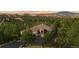 Aerial view of a beautiful home nestled amidst lush greenery with scenic mountain views at 6948 Fox Cir, Larkspur, CO 80118