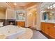 Elegant bathroom with a soaking tub, fireplace, and vanity at 6948 Fox Cir, Larkspur, CO 80118