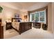 Bright bedroom featuring a work desk and large windows at 6948 Fox Cir, Larkspur, CO 80118