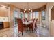 Dining room with tiled floor, large windows and chandelier at 6948 Fox Cir, Larkspur, CO 80118