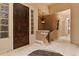 Elegant foyer featuring a decorative front door, tile flooring, and modern chandelier at 6948 Fox Cir, Larkspur, CO 80118