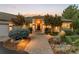 Charming single-story home featuring a brick pathway, well-manicured landscaping, and a welcoming entrance at 6948 Fox Cir, Larkspur, CO 80118