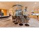 Open floor plan kitchen featuring bar seating, stainless steel appliances, and tile floors at 6948 Fox Cir, Larkspur, CO 80118