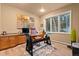 Home office featuring a modern desk, large window, and ample storage space at 6948 Fox Cir, Larkspur, CO 80118