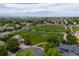 Stunning aerial shot of neighborhood, highlighting lush green spaces and mountain views at 13753 Monroe St, Thornton, CO 80602