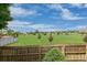 Scenic backyard view overlooking a sprawling green space and mature trees, enclosed by a classic wooden fence at 13753 Monroe St, Thornton, CO 80602