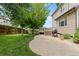 Spacious backyard featuring a well-maintained lawn, paved patio, and deck ideal for outdoor entertaining and relaxation at 13753 Monroe St, Thornton, CO 80602