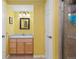 This bathroom features a shower, a granite sink, and yellow walls at 13753 Monroe St, Thornton, CO 80602
