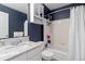 Full bathroom featuring a shower-tub combo and vanity with great countertop space at 13753 Monroe St, Thornton, CO 80602