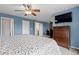This bedroom features a ceiling fan, a bed, and a TV at 13753 Monroe St, Thornton, CO 80602