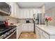 Updated kitchen with granite countertops, stainless steel appliances, and ample cabinet space for storage solutions at 13753 Monroe St, Thornton, CO 80602