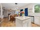 Bright kitchen boasts an island with granite countertops, pendant lights, and seamless flow into the living area at 13753 Monroe St, Thornton, CO 80602