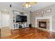 This open-concept living room boasts hardwood floors, a fireplace, and a built-in entertainment center at 13753 Monroe St, Thornton, CO 80602