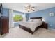 This main bedroom features a ceiling fan, large windows, and a bed at 13753 Monroe St, Thornton, CO 80602