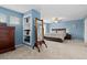 This main bedroom features a bed, built-in shelving, carpet flooring, and blue walls at 13753 Monroe St, Thornton, CO 80602