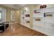 Finished basement with built-in shelving, hardwood floors, and ample storage space at 787 Eldorado Dr, Superior, CO 80027