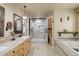 Modern bathroom with marble counters, soaking tub, and glass-enclosed shower featuring rainfall shower head at 787 Eldorado Dr, Superior, CO 80027