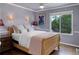 Comfortable bedroom featuring a ceiling fan and a bright window with a view of lush green trees at 787 Eldorado Dr, Superior, CO 80027