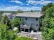 Back exterior elevation showcasing the home's architecture, patio area, and beautifully landscaped backyard at 787 Eldorado Dr, Superior, CO 80027