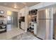 An open kitchen with stainless steel appliances, white cabinets, and tiled flooring at 787 Eldorado Dr, Superior, CO 80027