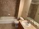 Bathroom with tub, sink, and tile floor at 7482 W Saratoga Pl, Littleton, CO 80123