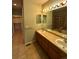 Double vanity bathroom with a large mirror and tile flooring at 7482 W Saratoga Pl, Littleton, CO 80123