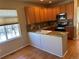 Kitchen boasts granite countertops, wood cabinets, and a breakfast bar at 7482 W Saratoga Pl, Littleton, CO 80123