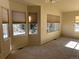 Bright living room with large windows, neutral carpeting, and ample natural light at 7482 W Saratoga Pl, Littleton, CO 80123