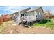 A backyard shows a well-maintained lawn and a grill by the back deck at 481 Vista Blvd, Brighton, CO 80603