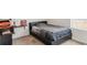 Bedroom featuring a modern bed with a dark frame and shelving at 481 Vista Blvd, Brighton, CO 80603