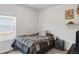 Cozy bedroom featuring a window and comfortable bed with a gray comforter at 481 Vista Blvd, Brighton, CO 80603
