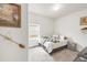 Inviting bedroom with white walls, a twin bed, and a window letting in natural light at 481 Vista Blvd, Brighton, CO 80603