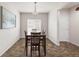 Bright dining area featuring a modern light fixture, window, and dark wood table and chairs at 481 Vista Blvd, Brighton, CO 80603