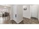 Hallway featuring neutral walls and flooring, with an adjacent dining area at 481 Vista Blvd, Brighton, CO 80603