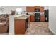 Kitchen view featuring wooden cabinets and modern appliances, with breakfast bar at 481 Vista Blvd, Brighton, CO 80603