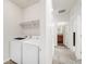 Convenient laundry room equipped with a modern washer and dryer, and additional shelving at 481 Vista Blvd, Brighton, CO 80603