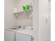 Laundry room with a washer, dryer, and shelving at 481 Vista Blvd, Brighton, CO 80603