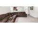 Spacious living room with a comfortable sectional couch and plush carpeting for relaxing at 481 Vista Blvd, Brighton, CO 80603