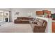 Spacious living room with a large sectional couch, adjacent to the kitchen at 481 Vista Blvd, Brighton, CO 80603
