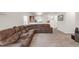 Open-concept living room with a large sectional couch and ample space at 481 Vista Blvd, Brighton, CO 80603