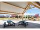A community playground with swings, slides, and picnic tables under a sheltered area at 481 Vista Blvd, Brighton, CO 80603