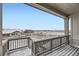 Balcony featuring wood floors and railings, offering scenic views of the surrounding snow-covered neighborhood at 3929 Treadway Pt, Castle Rock, CO 80108