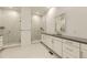 Bathroom featuring double sinks, a vanity, and a glass-enclosed shower at 3929 Treadway Pt, Castle Rock, CO 80108