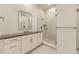 Bathroom featuring a sink, vanity, and a glass-enclosed shower at 3929 Treadway Pt, Castle Rock, CO 80108